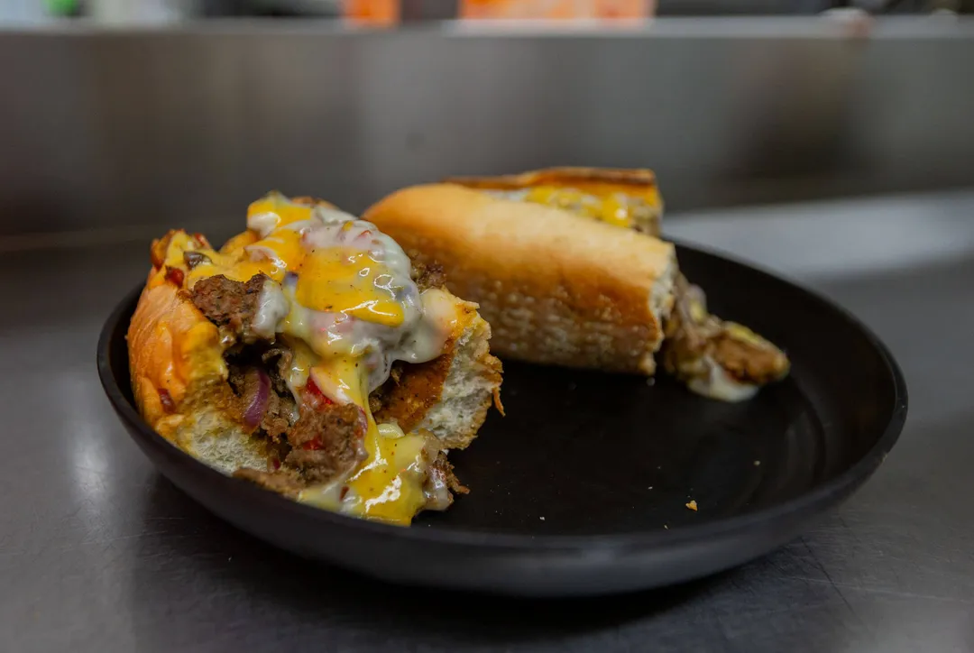 A loaded cheesesteak on a toasted roll