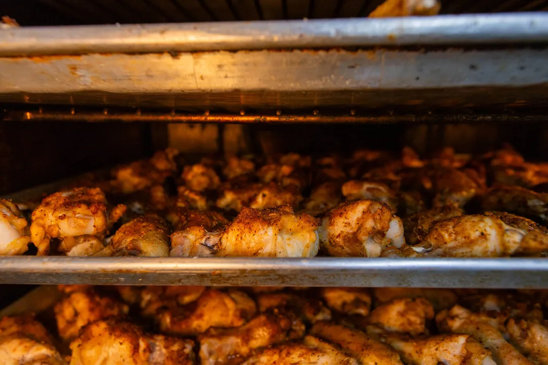 Trays of sauced wings fresh from the oven
