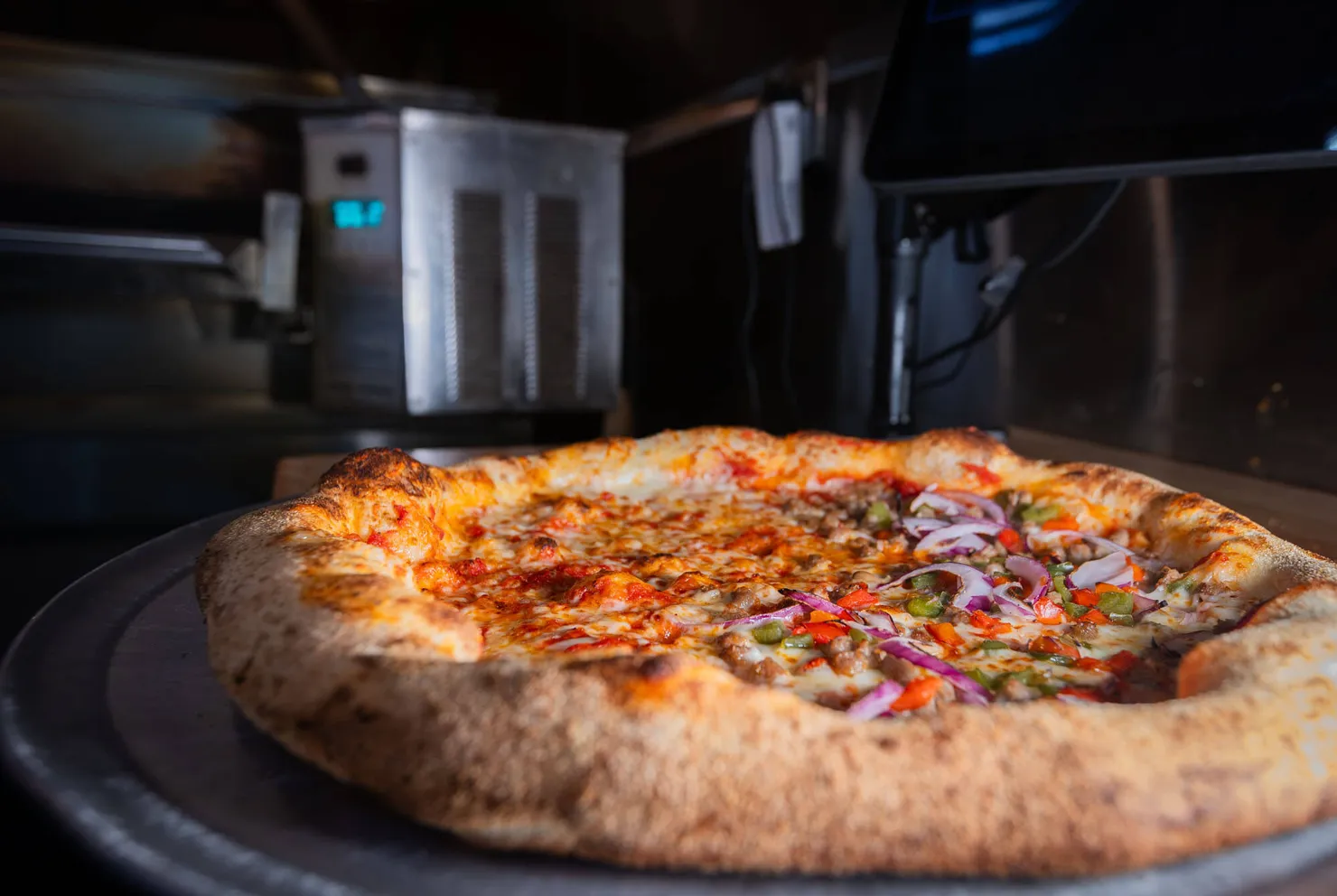 A supreme pie resting on the oven deck