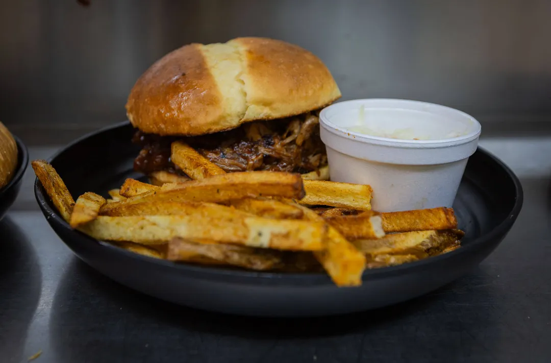 Pulled pork piled over hand-cut fries