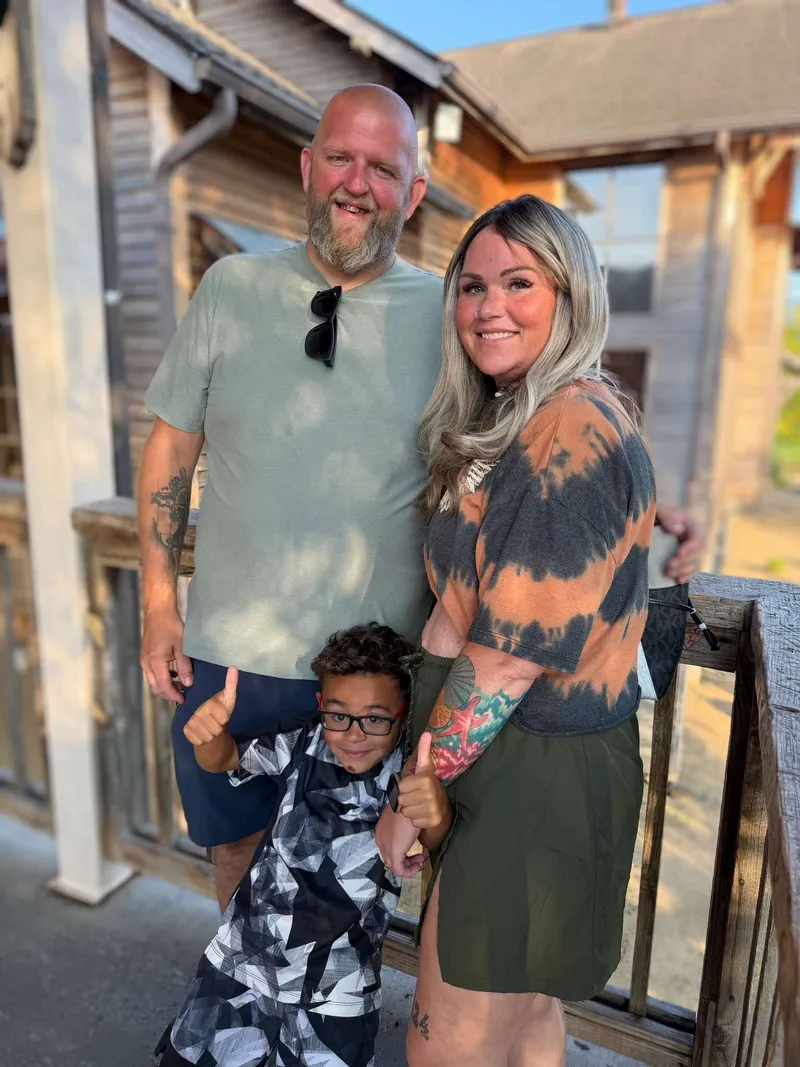 The Rebel Fork Kitchen family together outside on a wooden porch